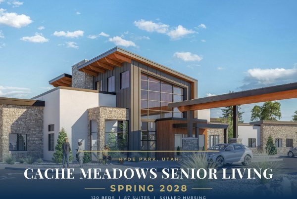 Rendering of a modern senior living center with stone and wood exterior, clear glass windows, and a blue sky (advertisement banner). It reads 'Cache Meadows Senior Living' coming 2028 in Hyde Park, Utah.